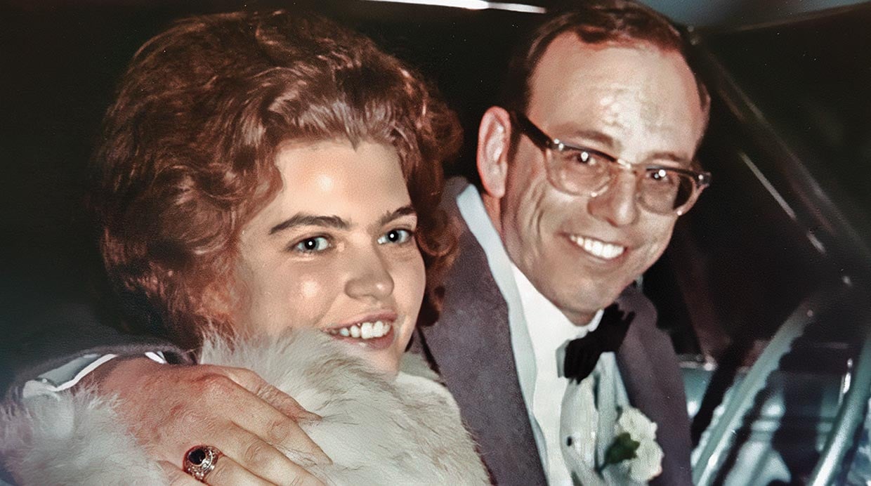 A photo of Jane and Ken Gremling from decades ago. They are wearing formal attire and sitting in a car, smiling for a photo.