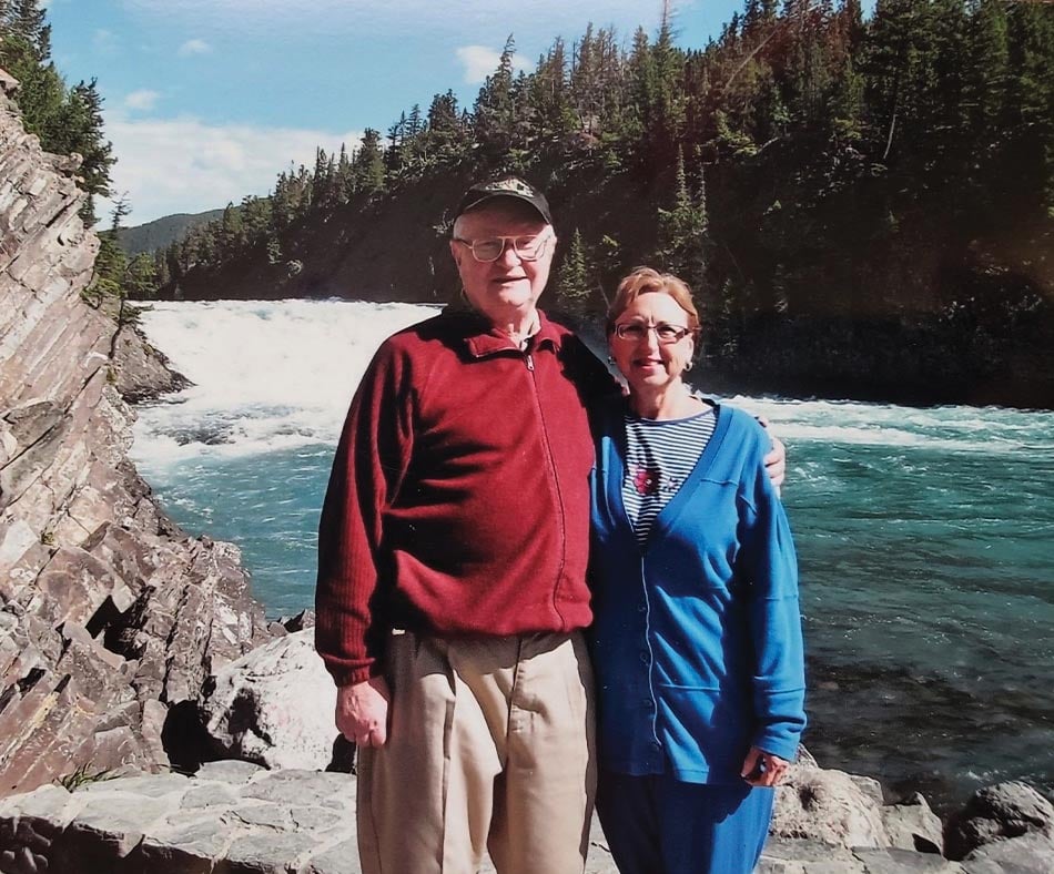 Gene and Ellen Braun standing in front of a rapid