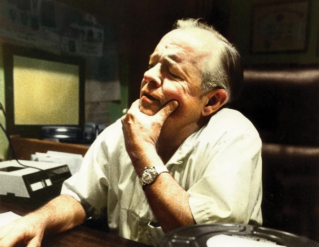 Dr. F. Mason Sones sitting at a desk with his hand on his chin, looking out of frame.