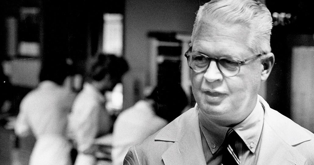 Dr. Fay LeFevre wearing a medical coat, a dress shirt and stripped tie, looking out of frame