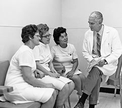 Dr. Rupert Turnball, MD with 3 women