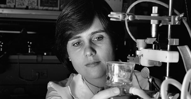 Christine Moravec, PhD holding a glass tool
