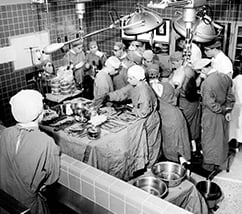 grayscale photo of doctors operating on a patient