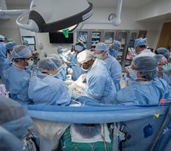 group of surgeons performing surgery on a patient