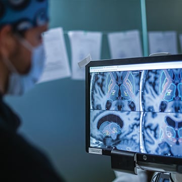 A man looks at brain scan images