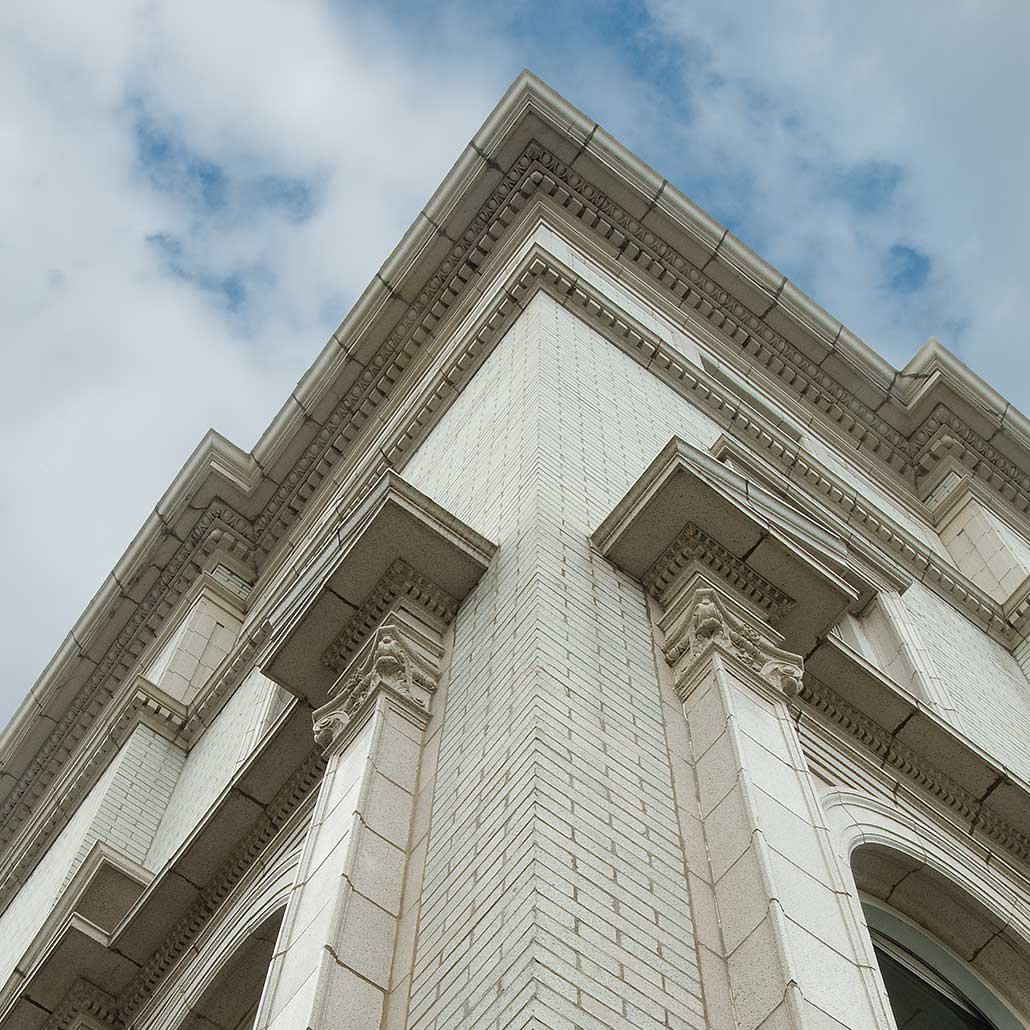 A perspective photo of a white building with detailed architecture