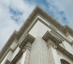 A perspective photo of a white building with detailed architecture