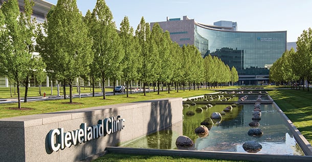 Cleveland Clinic Meller building in the background with trees and a water feature in the foreground