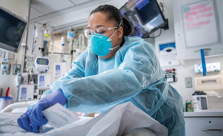 Female doctor applying a tag to a patiet bed