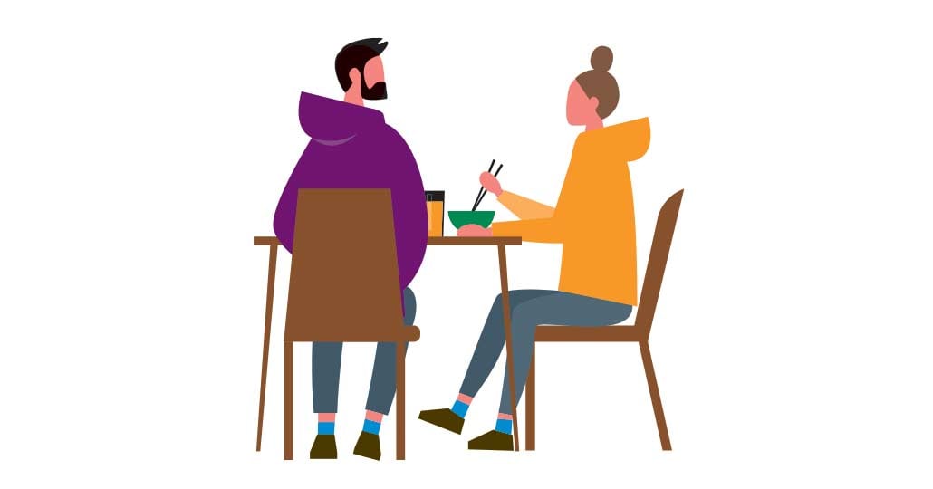 Two people eating at a table