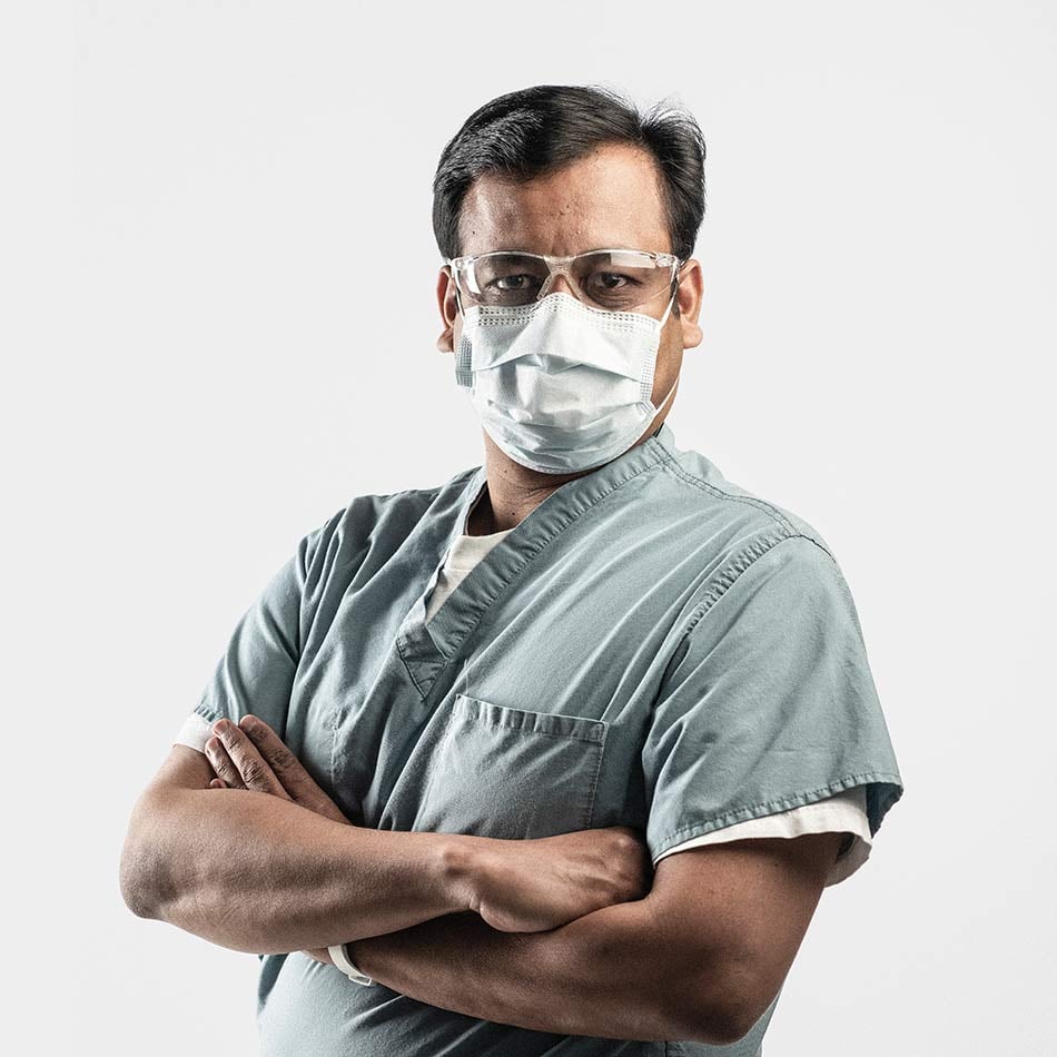 Debasis Sahoo posing for photo with arms crossed wearing a face mask