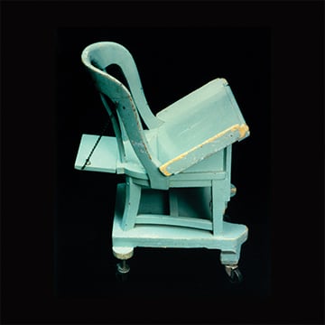 A seafoam green wooden chair