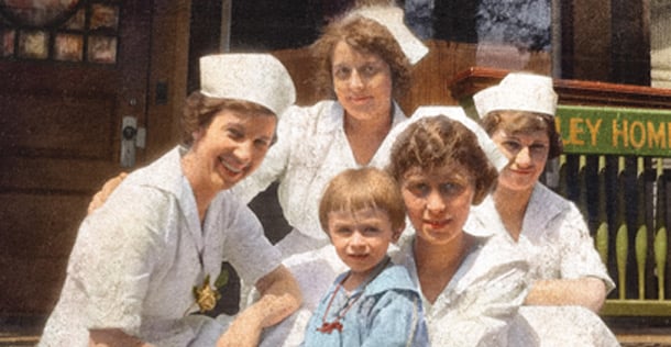 four nurses and a girl on steps in front of office in 1920s