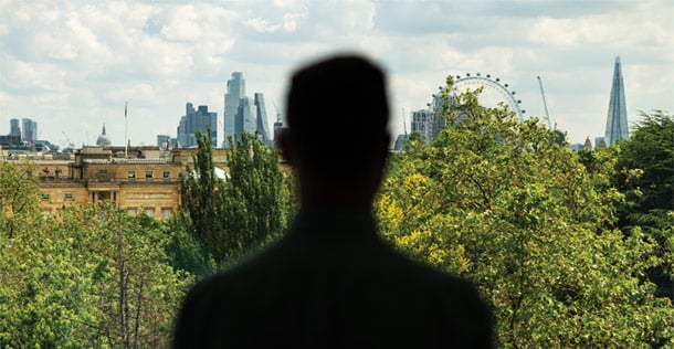 Silhouette of man in front of panorama view of London