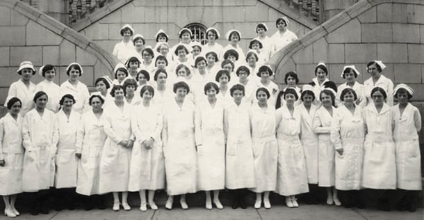 1925 photo of nurses standing in front of stone building