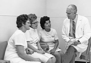 Dr. Rupert Turnball, MD with 3 women
